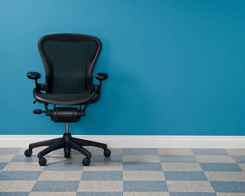Single office chair in austere office.*